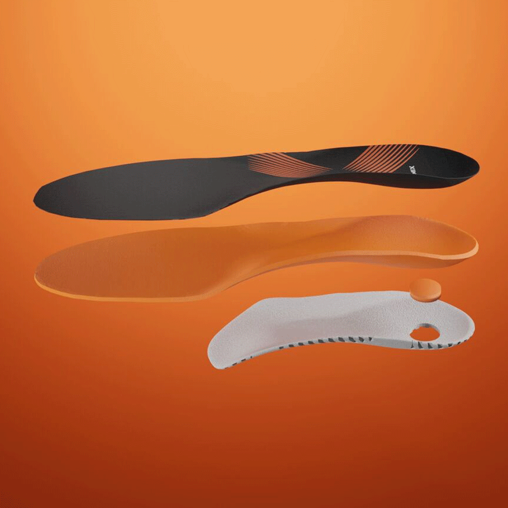 A disassembled Comfort-style shoe insole, displaying the top cover, padding, custom bottom shell, and heel pad.